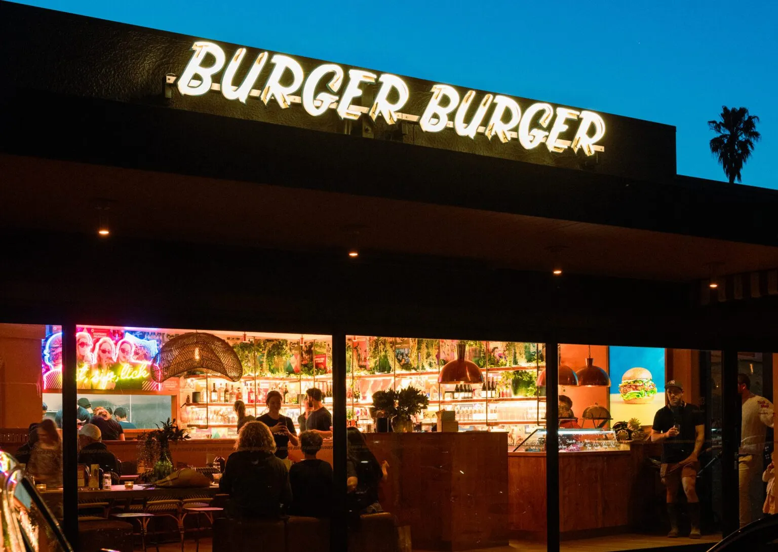 Burger Burger Waiake at night with illuminated signage and interior lighting by Vital Energy