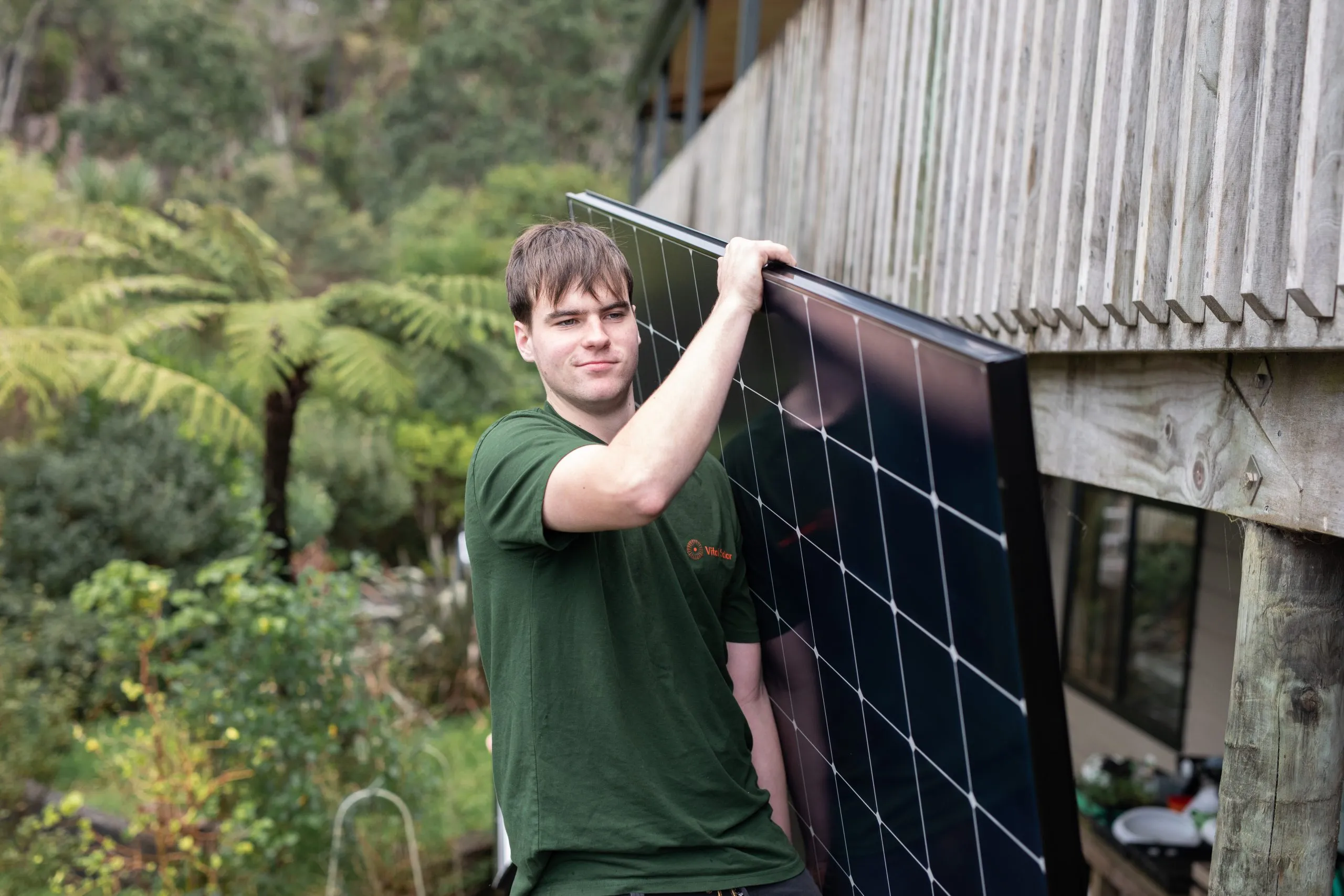 Vital Energy installer carrying a solar panel